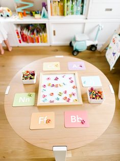 a child's play table with letters and magnets on it in a room