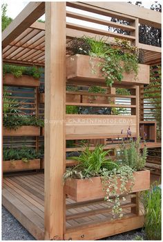 a wooden structure with plants growing on it's sides and attached to the roof