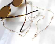 more sunglasses chain in DearDanielleJewelry: https://www.etsy.com/shop/DearDanielleJewelry?ref=seller-platform-mcnav&section_id=28433527 gold beads sunglasses chain, gold beads glasses chain necklace. **framed gems, and charms in the jewelry is plated. *All the jewelry in my shop will be sent in cotton pouch. If you want gift box wrapping, please let us know we will send your jewelry in gift box. Beads Sunglasses, Beads Glasses, Beaded Sunglasses, Chain Mask, Tortoise Glasses, Sunglasses Chain, Gold Glasses, Mask Chain, Sunglass Chain