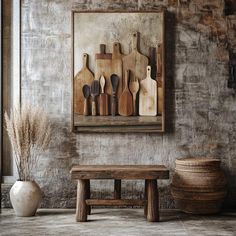 a wooden bench sitting in front of a painting on the wall