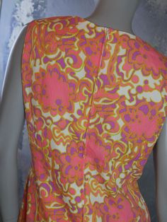 This 1960s sheath dress has a stunning abstract floral pattern in pink, purple, and pale chartreuse on a cream background. The sleeveless summer dress is crafted from an accordion textured viscose fabric. Note that the stitched hemline has been let out at some point, and so you can leave it as is or hem it to your preferred length (see pix). Bust = 38 inches (96cm) Waist = 36 inches (91.44cm) Hips = 42 inches (106.68cm) Dress Length = 41 inches (104.14cm) Back Zipper = 20 inches (50.8cm) Size: 1 Fitted Sleeveless Dress With Vintage Pattern, Pink Sleeveless Dress With Retro Print, 1970s Sleeveless Vintage Dress For Spring, Pale Chartreuse, Mad Men Dresses, 1968 Pink & Orange Dress, Sleeveless Summer Dress, Formal Cocktail Party, 1970s Fitted Vintage Print Dress