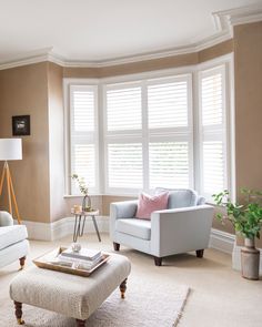 a living room filled with furniture and windows