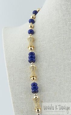 "27\" necklace of faceted dark blue Lapis Lazuli rondelles, 8mm gold filled beads, 5x3mm gold filled melons, 15mm x 9mm gold plated CZ pavé beads, 23K gold plated clasp with Swarovski crystals. Beautiful dark Lapis Lazuli, gold and sparkly CZ's make a wonderful combination and will really add pizzazz to any attire, especially one for a festive evening out. The gold beads will not tarnish because they are gold filled and will look beautiful for the next 20 or 30 years. Please know that this neckl Formal Blue Faceted Necklaces, Formal Blue Faceted Necklace, Blue Faceted Lapis Lazuli Jewelry, Faceted Blue Lapis Lazuli Jewelry, Blue Faceted Briolette Necklace, Blue Briolette Faceted Necklace, Lapis Lazuli Necklace With Faceted Beads, Round Lapis Lazuli Necklace With Faceted Beads, Faceted Sapphire Lapis Lazuli Necklace