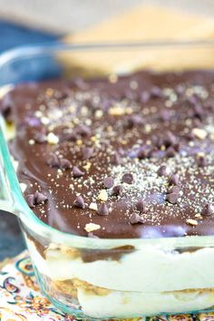 a chocolate dessert in a glass dish with sprinkles