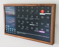 a wooden framed calendar hanging on the wall