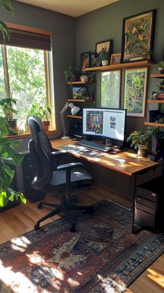 a home office with two computers on the desk and plants in the window sill