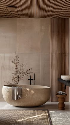 a bath tub sitting next to a window in a room with wooden slats on the walls