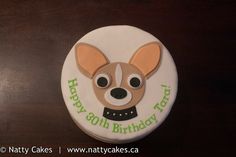 a birthday cake with a dog's face and name written on the top layer