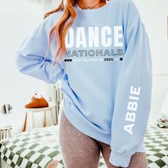 "Custom Dance Nationals Sweatshirt, Personalized Sleeve Competition Dance Crewneck, Competitive Dance Gear, Dance Unisex Comfort Colors How To Order - Please make sure you have looked at all sizes and color charts. - Select from the various T-shirt sizes and colors from scroll-down menus. - Fill in the personalization box (if provided) as exemplified. - Click \"Add to cart\" button. You can turn back and add more items of different size and color. Order Process - Our processing time is 5-10 days Dance Team Nationals Shirts, Dance Nationals Shirts, Hip Hop Crew Neck Top For Dance, Hip Hop Style Crew Neck Top For Dance, Hip Hop Long Sleeve Sweatshirt For Dance, Relaxed Fit Long Sleeve Tops For Dance Class, Long Sleeve Letter Print Top For Dance Class, Long Sleeve Tops With Letter Print For Dance Class, Stretch Long Sleeve Tops For Dance Class