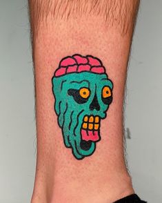 a man's foot with a tattoo on it that has an image of a skull