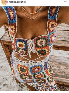 a woman wearing a colorful crochet swimsuit on the beach