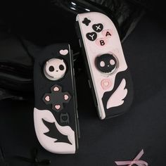 two black and white remote controls sitting next to each other