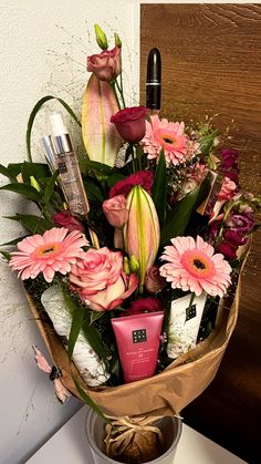 a bouquet of flowers in a bucket on a table