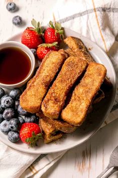 french toast with strawberries and blueberries on a plate