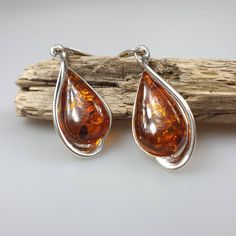 Gemstone Earrings. Sterling silver 925 earrings with genuine Baltic Amber gremstone and all hallmarks. Length: 5 cm. One pair included. Each pair has a different shade of brown colour. The same model is also available in green Amber colour.: https://www.etsy.com/listing/1064943153/green-amber-earrings-sterling-silver-925?ref=listings_manager_grid This item was made of natural Baltic Amber. All the amber used in my jewelry is collected in my home country Lithuania. I sell only genuine, real, not Polished Drop Earrings For Gift, Polished Finish Drop Earrings For Gift, Hallmarked Drop Earrings, Silver Teardrop Earrings With Polished Finish For Gift, Classic Amber Sterling Silver Earrings, Amber Sterling Silver Dangle Earrings, Sterling Silver Clip-on Drop Earrings, Amber Sterling Silver Earrings, Amber Dangle Earrings For Anniversary