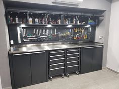 a large metal workbench with lots of drawers and tools on the top shelf