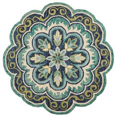 a blue and green rug with an ornate design on the center, in front of a white background