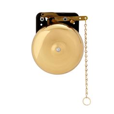 a golden bell hanging from a chain on a white wall with a light bulb attached to it