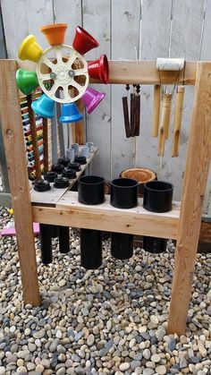 a wooden bench with pots and cups on it