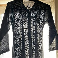 Kurtan Style Short Tunic. Black-On-Black Embroidery. Two Side Slits. Pull Over V Neck. Very Chic With Black Leggings Or A Black Skirt. Crisp And Never Worn. Black Resham Embroidered Kurta For Spring, Traditional Black Kurta For Spring, Black Traditional Summer Kurta, Black Floral Embroidered Kurta For Party, Traditional Black Summer Kurta, Black Long Sleeve Kurta For Spring, Fitted Black Spring Kurta, Embroidered Black Tunic Kurta, Fitted Black Kurta With Floral Embroidery