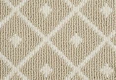 a beige and white rug with diamonds on it