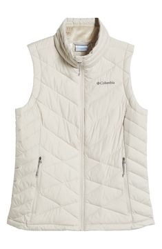 This quilted vest combines thermal reflective technology and plush fill so you'll stay warm to your core on trail walks or strolls through town. A cozy, fleece lined collar brings warmth up close when you need it most and front zip pockets let you carry the essentials. 25" length Front zip closure Stand collar Water repellent Front zip pockets Lined, with polyester fill 100% polyester Machine wash, tumble dry Imported Winter Windproof Hiking Vest, Winter Hiking Windproof Vest, Quilted Winter Vest For Outdoor, Quilted Winter Outdoor Vest, Winter Vest With Fleece Lining For Outdoor Activities, Winter Hiking Vest With Fleece Lining, White Outdoor Vest For Fall, White Sleeveless Outdoor Outerwear, Quilted Vest