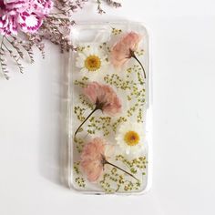 an iphone case with pink and white flowers on it