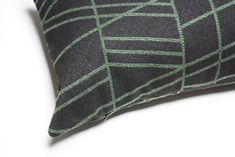 a black and green pillow sitting on top of a white table