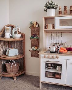 a kitchen area with an oven, microwave and shelves