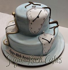 there is a blue cake with two clocks on it