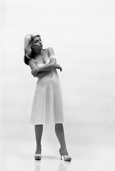 a black and white photo of a woman with her arms crossed