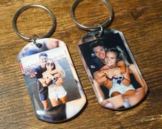 two personalized key chains with an image of a man and woman on them are sitting on a wooden table