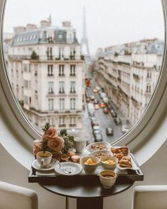 an instagram photo with food and drinks on a table in front of the eiffel tower