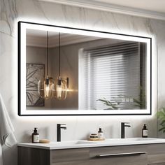 a bathroom with a large mirror and two lights on the wall above it, next to a sink