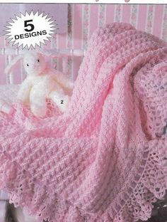 a crocheted baby blanket with a teddy bear sitting on it in the corner