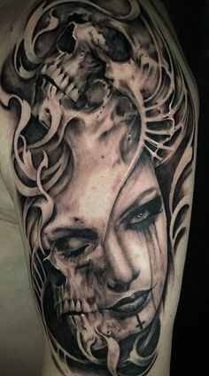 a woman's face and skull tattoo on the back of her arm, with black ink