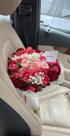 a bouquet of flowers in the back seat of a car