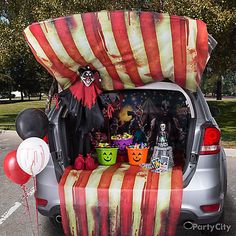 a car decorated for halloween with decorations and balloons