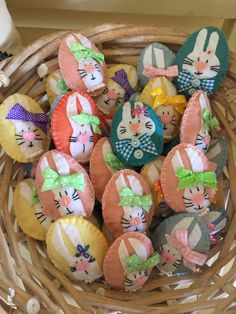 a basket filled with small stuffed animals in it's ears and bows on top of each other