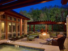 an outdoor hot tub and seating area at night