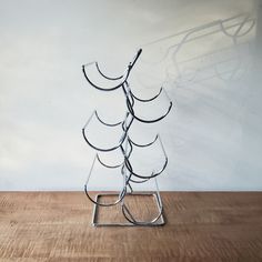 a metal sculpture sitting on top of a wooden floor