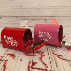 two red valentine's day mailboxes with writing on them