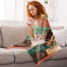 a woman sitting on a couch holding a coffee cup