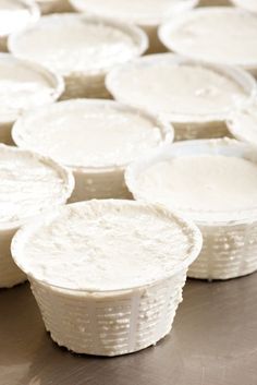 many plastic cups are lined up on the table top, ready to be used as desserts