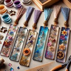 the bookmarks are decorated with flowers and other crafting supplies, along with scissors