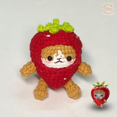 a crocheted stuffed animal next to a tiny strawberry