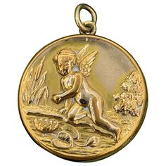 This is a wonderful and rare antique Victorian - Art Nouveau Cherub, Angel, Cupid Locket with Cupid in a Lily Pond with Lily Pads, Flowers, Cattails and Trees. The design is absolutely exquisite and very rare. The locket is gold filled. The image is full of the delights of nature along with the wonderful angel. The locket is so full of romance, tranquility and peace. It is a very special piece. The reverse is decorated with an engraved monogram. This is one of the rarest antique angel motif lock Pond With Lily Pads, Victorian Cherub, Pond Art, Angel Cupid, Cherub Angel, Art Nouveau Pendant, Lily Pond, Victorian Art, Lily Pads