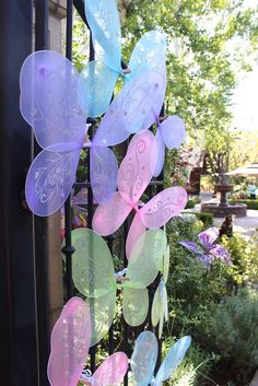 a wind chime hanging from a metal fence