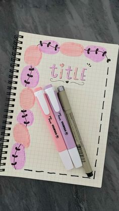 a notepad with two pens on top of it and the word little written in cursive writing