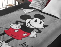 a mickey mouse comforter is shown on a bed